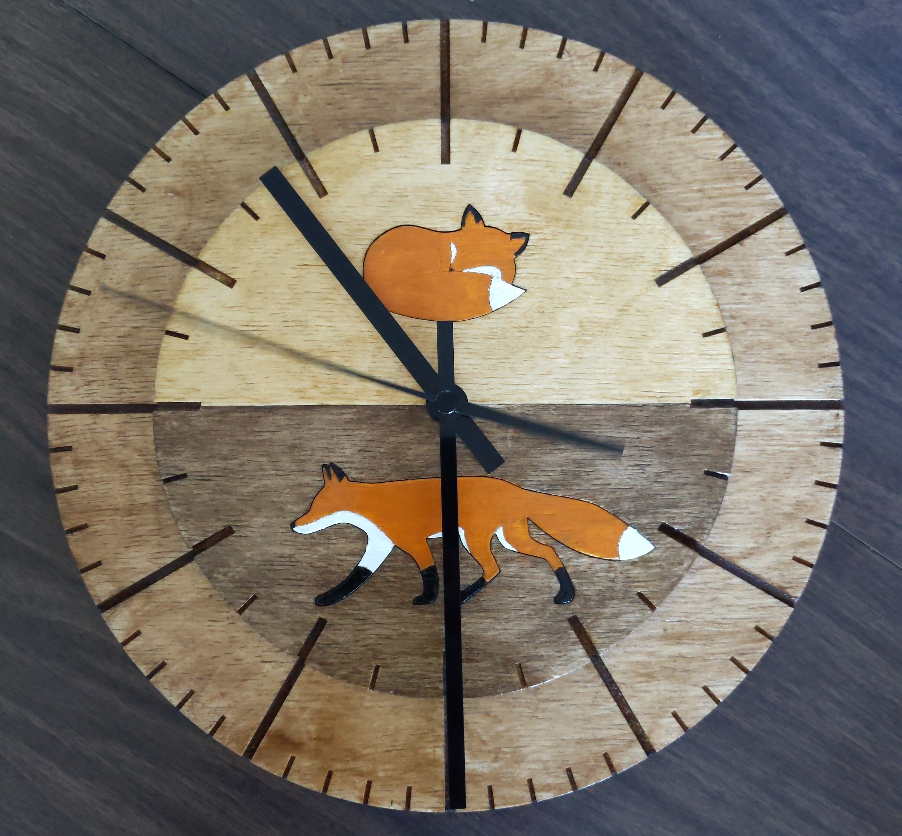 a clock with two images of foxes